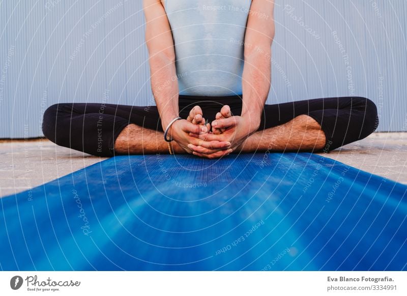 man in the city practicing yoga sport. blue background. healthy lifestyle Yoga Man Sports Healthy Exterior shot City Blue background Muscular