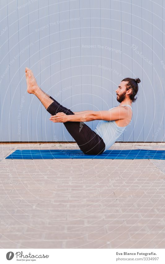 man in the city practicing yoga sport. blue background. healthy lifestyle Yoga Man Sports Healthy Exterior shot City Blue background Muscular