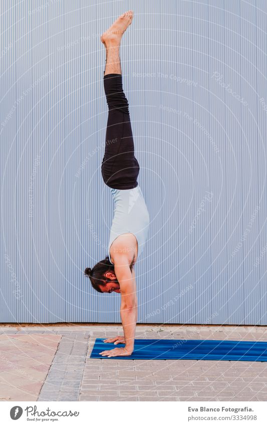 man in the city practicing yoga sport. blue background. healthy lifestyle Yoga Man Sports Healthy Exterior shot City Blue background Muscular