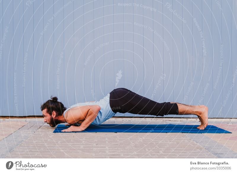 man in the city practicing yoga sport. blue background. healthy lifestyle Yoga Man Sports Healthy Exterior shot City Blue background Muscular