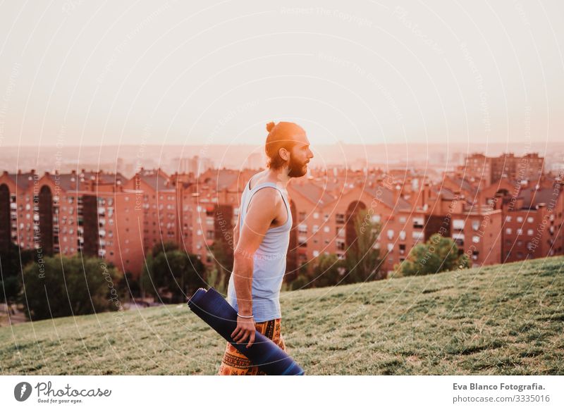 young man in a park ready to practice yoga sport. city background Man Youth (Young adults) Yoga Sports City Park Sunset Lifestyle Healthy Mat sport clothes