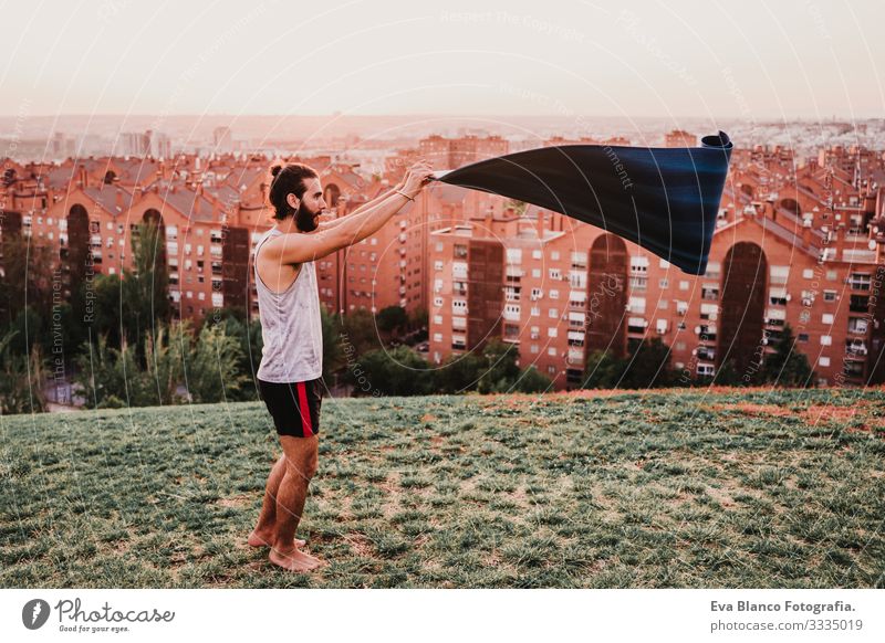 young man in a park ready to practice yoga sport. city background Man Youth (Young adults) Yoga Sports City Park Sunset Lifestyle Healthy Mat sport clothes