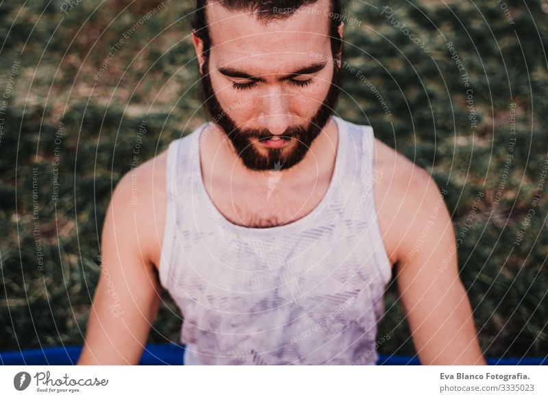 young man in a park practicing yoga sport. city background. healthy lifestyle. Man Youth (Young adults) Yoga Sports City Park Sunset Lifestyle Healthy Mat