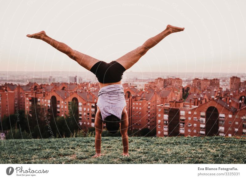 young man in a park practicing yoga sport. city background. healthy lifestyle. Man Youth (Young adults) Yoga Sports City Park Sunset Lifestyle Healthy Mat