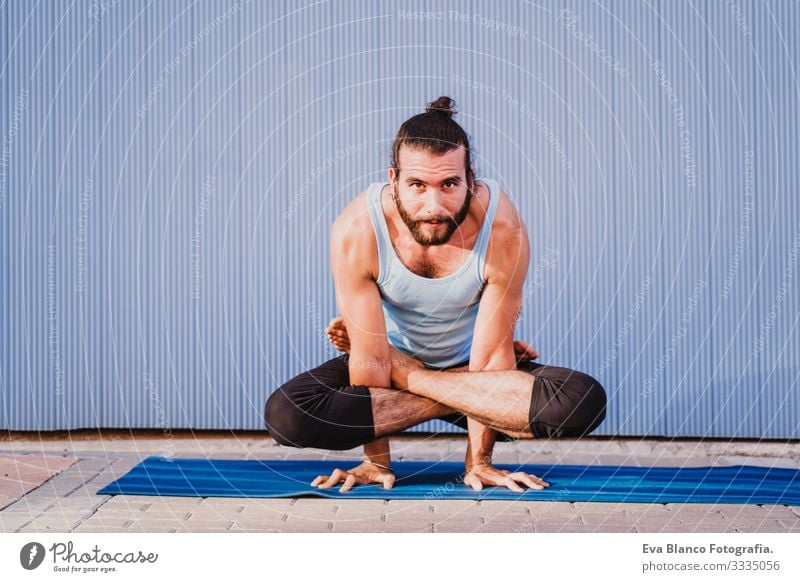 man in the city practicing yoga sport. blue background. healthy lifestyle Yoga Man Sports Healthy Exterior shot City Blue background Muscular