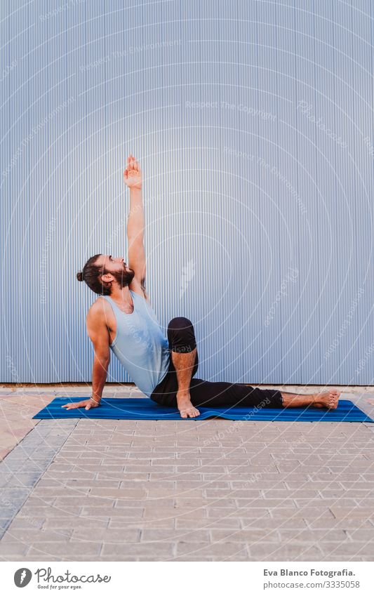 man in the city practicing yoga sport. blue background. healthy lifestyle Yoga Man Sports Healthy Exterior shot City Blue background Muscular