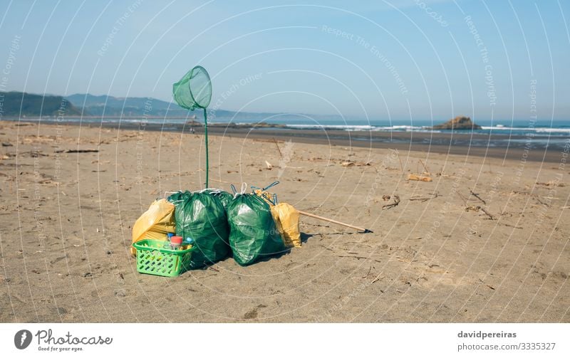 Garbage bags and utensils on the beach Beach Ocean Environment Nature Landscape Sand Coast Clean Disaster Teamwork garbage bags after volunteering