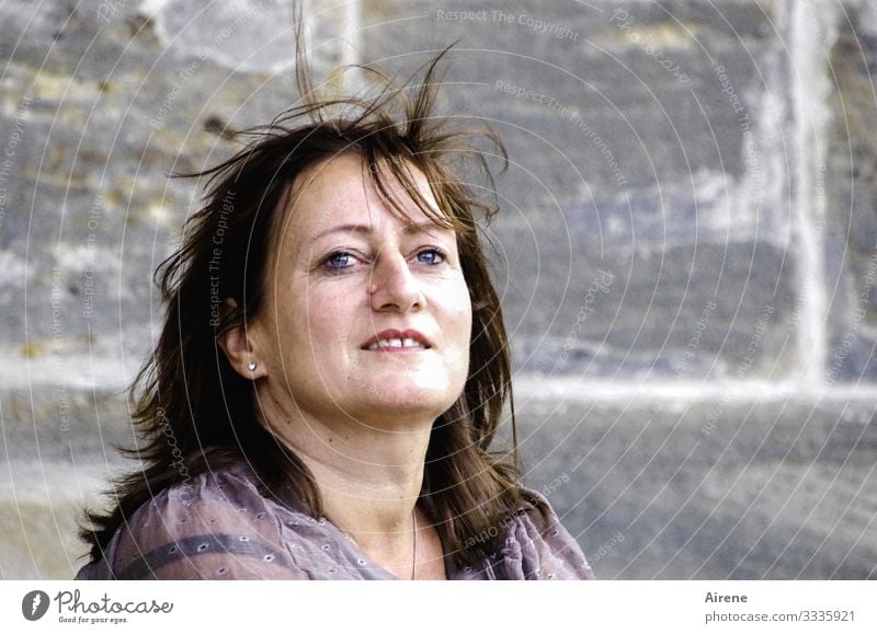 By the city wall... Woman Feminine kind smile Airy Joy luck Stone wall optimistic Optimism Brown Gray Cheerful Wall (barrier) portrait already Human being