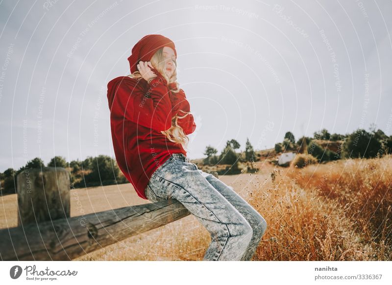 Young and blonde woman enjoying a sunny and quiet day though calm scene tranquility silence comfort feeling of comfort life alone backlight natural summer