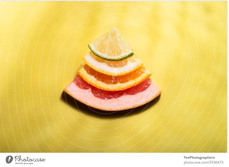 Citrus fruits slices in sunlight. Mix of citrus fruits Food Fruit Orange Nutrition Fresh Bright Sweet Multicoloured Yellow Red above view cheerful citrus stack