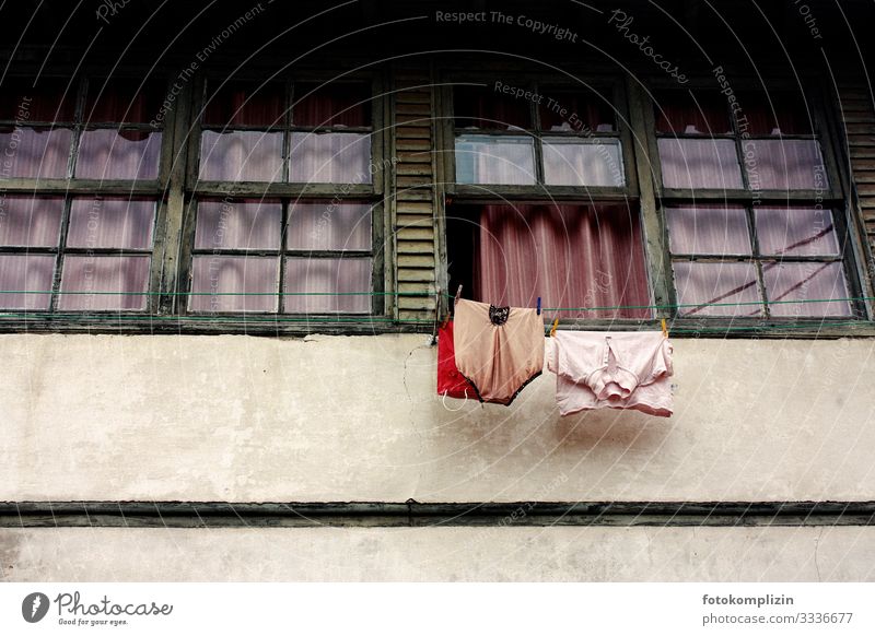 Clothesline in front of an open window of a southern window front clothesline Old fashioned Underwear Nostalgia Retro Cleanliness Modest Senior citizen Poverty