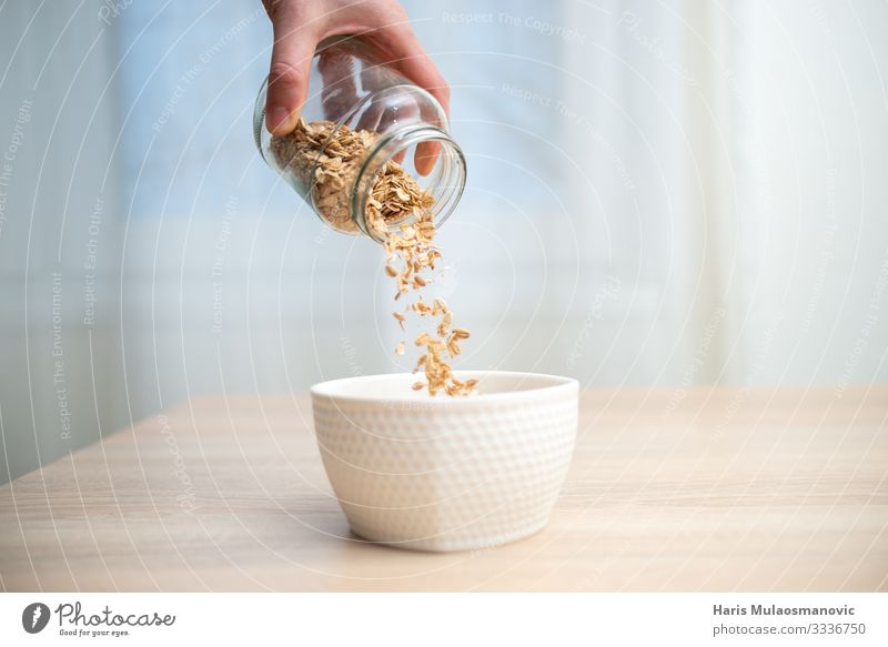 Cereal breakfast pouring in the bowl on the table Food Nutrition Eating Breakfast Business lunch Organic produce Vegetarian diet Diet Cold drink Bowl Lifestyle