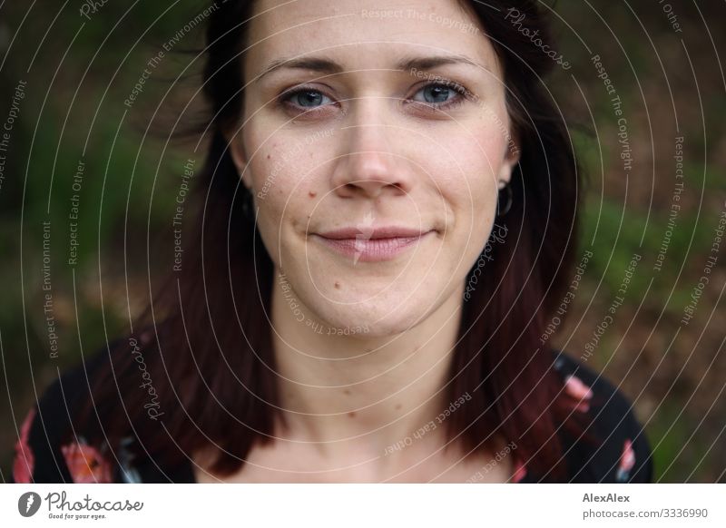 Portrait of a young woman with a subtle smile Lifestyle Joy already Well-being Young woman Youth (Young adults) Face 18 - 30 years Adults Beautiful weather