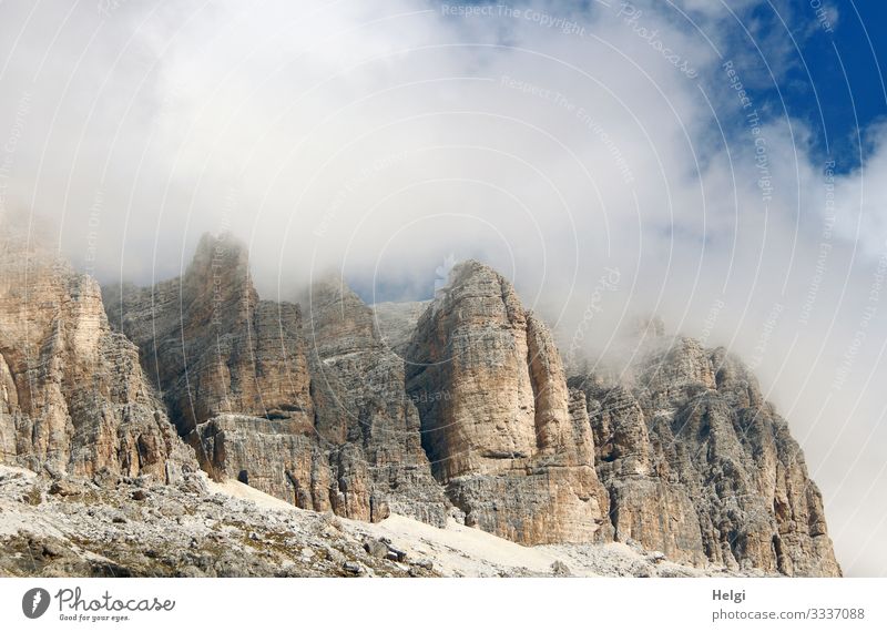 Gigantic mountains of the Alps wrap themselves in thick clouds in the sunshine Environment Nature Landscape Sky Clouds Autumn Rock Mountain Dolomites Stand