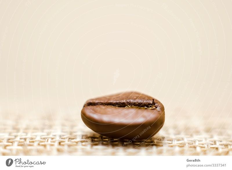 one grain of coffee on a matting macro Breakfast Coffee Cloth Dark Fresh Natural Brown Black Energy Colour Aromatic backdrop background Beans Beige blur blurry