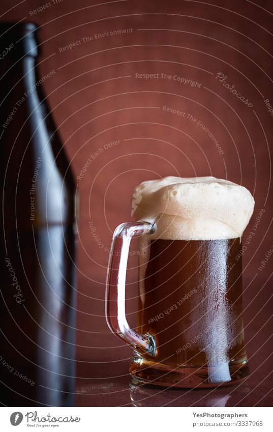 Black beer in a pint with foam. Dark beer mug. Cold drink Beverage Beer Cup Bottle Glass Table Restaurant Feasts & Celebrations Fresh alcohol beverage bar