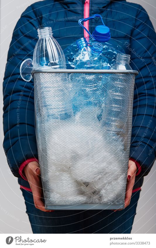 Woman holding trash bin with collected used plastic packagings Bottle Adults 1 Human being Environment Container Package Plastic Throw Blue