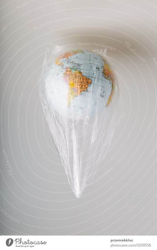 Globe in a plastic bag. Earth contaminated by plastic waste Save Life Environment Plastic packaging Sphere Green Environmental pollution