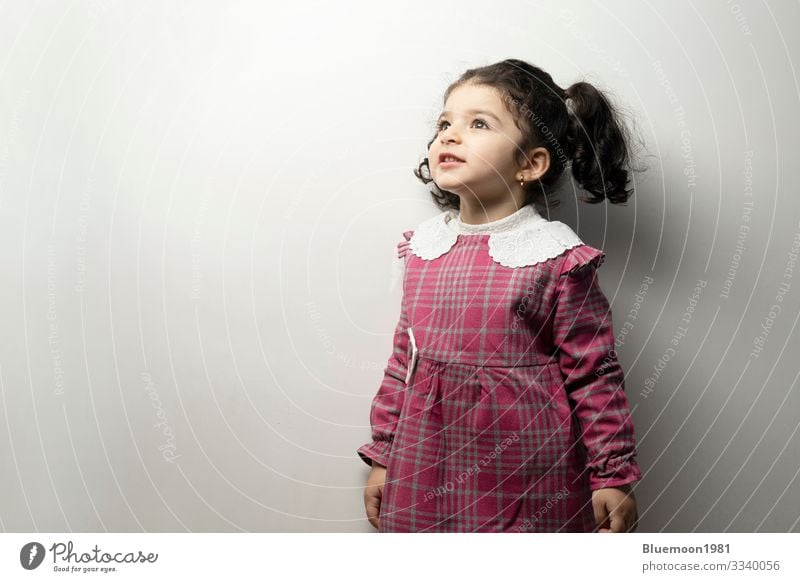 Little girl with side pony hairstyle looking outside of frame center parted hairstyle two years care healthy portrait little girl fashion beauty child children