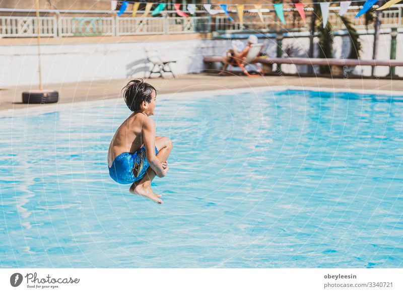 young asina boy jumping into the swimming pool Joy Happy Face Relaxation Swimming pool Leisure and hobbies Playing Vacation & Travel Summer Sports Success Child