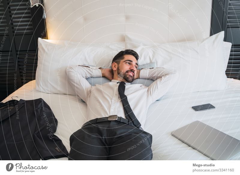 Businessman taking a break from work at hotel room. Lifestyle Relaxation Vacation & Travel Trip Bedroom Success Work and employment Profession Human being Man