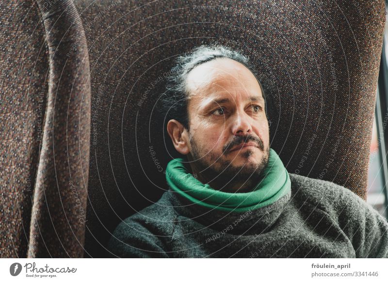 Man sitting in armchair Portrait photograph Long-haired 45 - 60 years Human being 1 Adults Masculine Facial hair Head Face Day Copy Space left Subdued colour