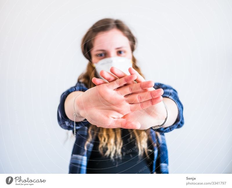 Young woman with mouth guard and stop gesture Health care Illness Feminine Youth (Young adults) Life Hand Fingers 1 Human being 18 - 30 years Adults