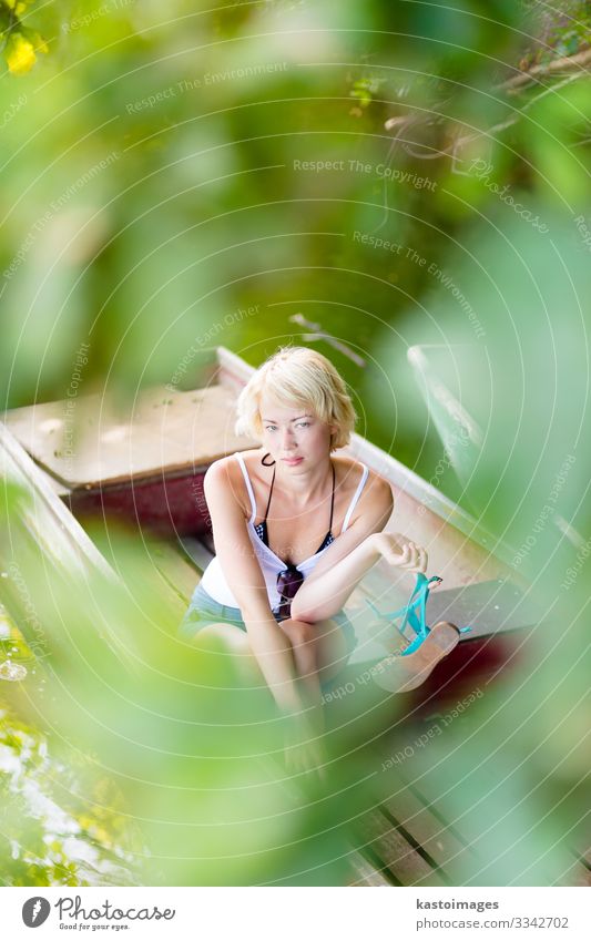 Woman relaxing on the vintage wooden boat. Lifestyle Joy Beautiful Relaxation Leisure and hobbies Freedom Summer Mirror Human being Adults Environment Nature