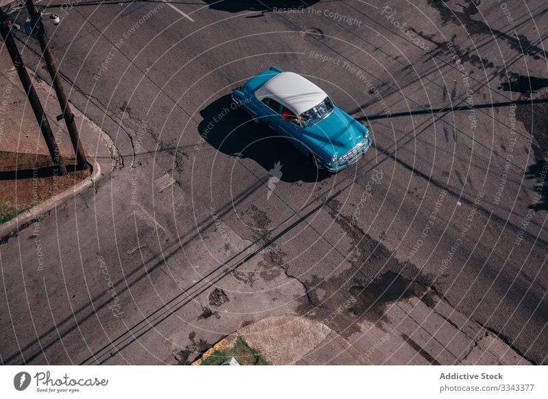 Retro car among on road of city street vintage intersection asphalt red transport town old travel trip vehicle summer retro vacation lifestyle journey urban