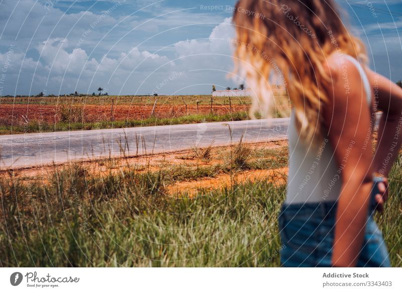 Female tourist amid green plants at farmland woman field countryside rural overcast cloudy heaven sky female casual standing summer nature agriculture young