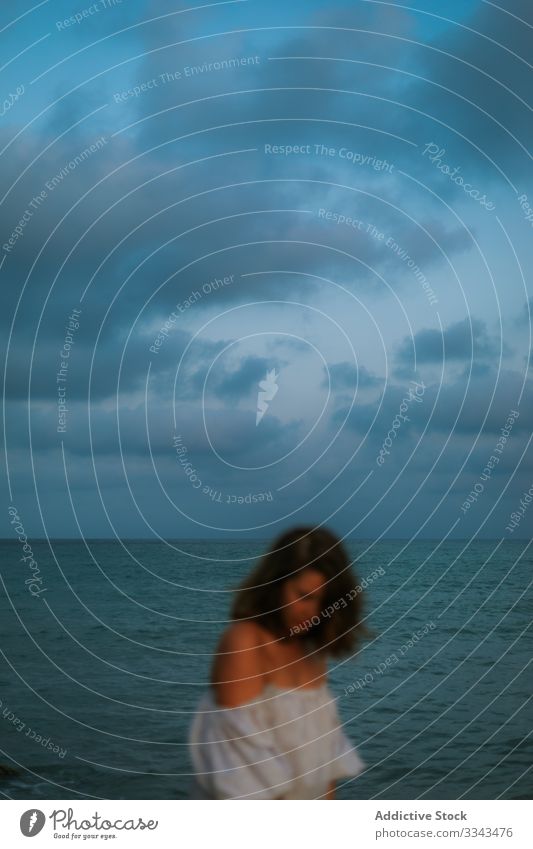 Female tourist seaside woman beach waves seashore sky heaven dusk clouds female lady walking coastline empty lonely blue dress beautiful vacation water ocean