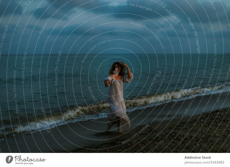 Female tourist seaside woman beach waves barefoot seashore sky heaven dusk clouds female lady walking coastline empty lonely blue dress beautiful vacation water