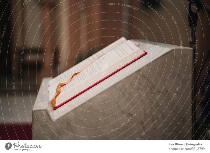 holy bible on table during a wedding ceremony nuptial mass. Religion concept. Catholic eucharist ornaments for the celebration of the Eucharist Open Holy