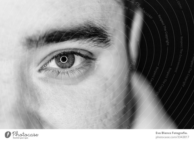 close up half side portrait of a young man. studio shot. led ring reflection in the eyes Head White Human being Man Black Dramatic Lifestyle Close-up 1