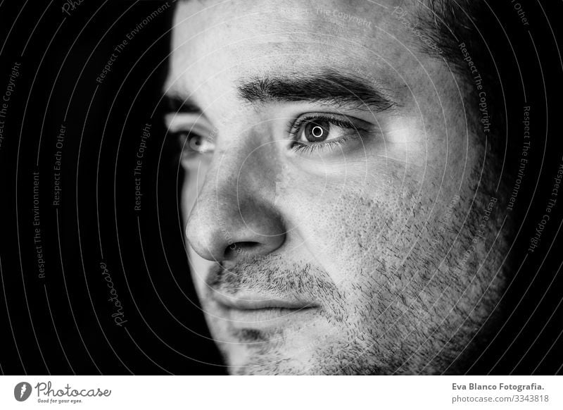 close up half side portrait of a young man. studio shot. led ring reflection in the eyes Head White Human being Man Black Dramatic Lifestyle Close-up 1