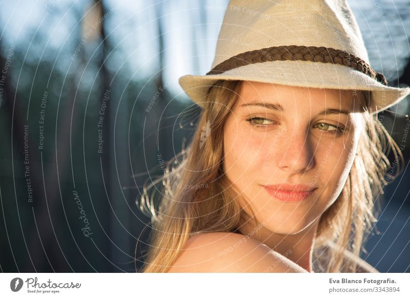 portrait of a young woman at sunset Portrait photograph Youth (Young adults) Woman Exterior shot Happy Blonde Hat blue eyes Bridge Summer Sunbeam Hair Happiness