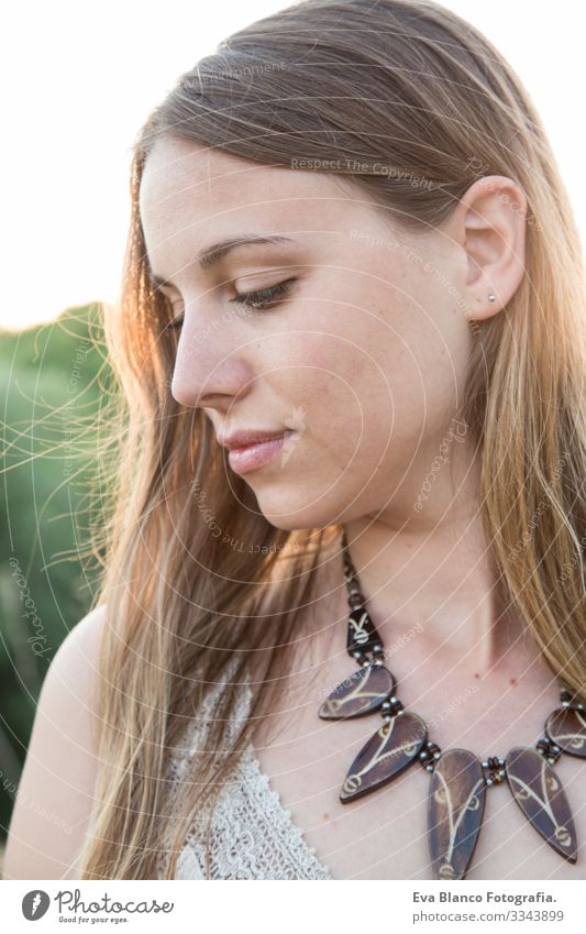 portrait of a beautiful woman at sunset Portrait photograph Youth (Young adults) Woman Exterior shot Happy Blonde blue eyes Bridge Summer Sunbeam Hair Happiness