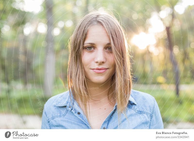 outdoors portrait of a beautiful young woman looking at the camera and smiling. Woman posing at sunset Youth (Young adults) Happy Beautiful Portrait photograph