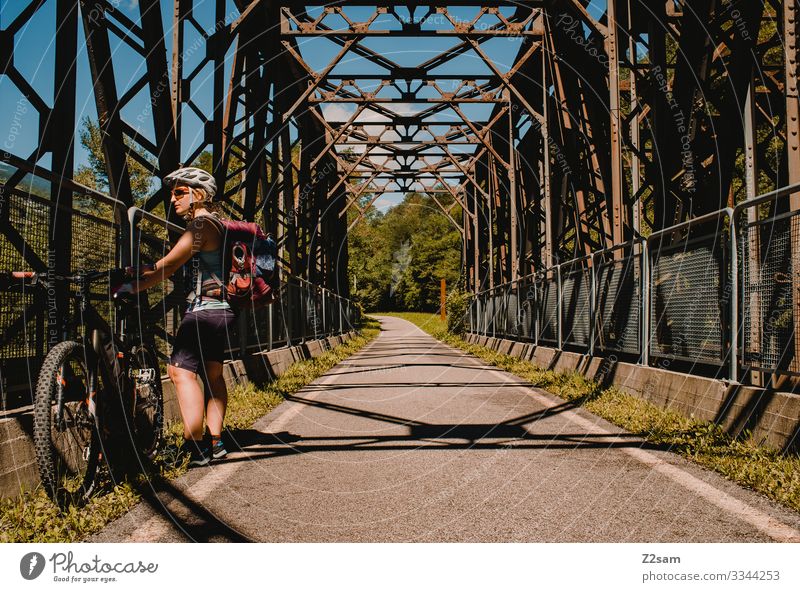 Break on the bike tour alpine crossing Lake Garda Mountain bike mtb transalp bicycle trip Young woman Athletic Athlete vacation free time Freedom