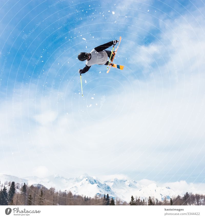 Free style skier. Lifestyle Joy Relaxation Adventure Winter Snow Mountain Sports Nature Park Alps Movement Jump Speed Blue White Brave Safety Dangerous Skier