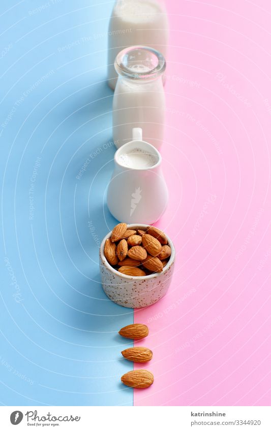 Vegan almond milk on a pink and blue background Vegetable Nutrition Breakfast Vegetarian diet Diet Beverage Bottle Fresh Natural Blue Pink Alternative almonds