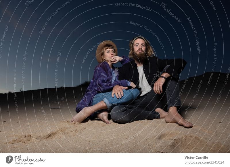 A young couple outdoors enjoying a sunset in the beach Lifestyle Elegant Style Human being Masculine Feminine Young woman Youth (Young adults) Young man Woman