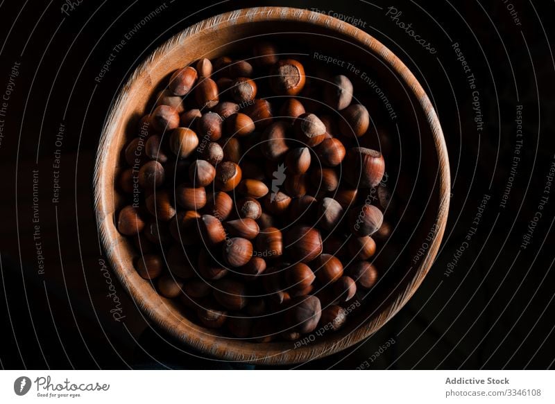 Harvest of ripe hazelnuts in wooden bowl harvest full heap table healthy food nutshell brown ingredient natural nutrition organic raw snack tasty whole seasonal