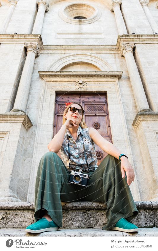 Young woman on church steps in old town in Tuscany Lifestyle Vacation & Travel Tourism Trip Sightseeing City trip Camera Human being Feminine