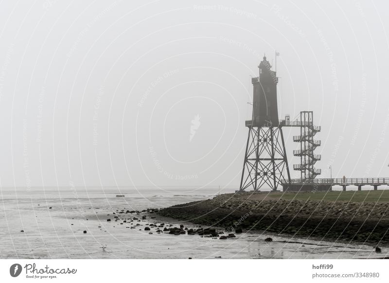 Tower in the fog Clouds Autumn Winter Bad weather Fog Rain Coast North Sea Mud flats Harbour Lighthouse Footbridge Mole Stairs Roof Esthetic Dark Elegant