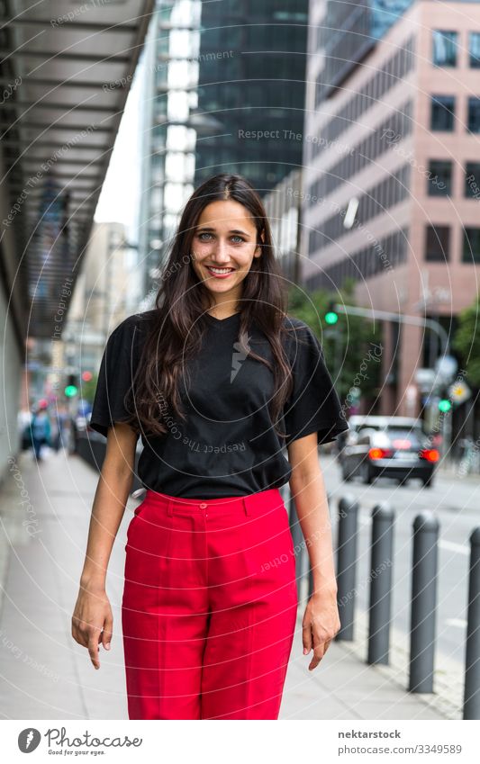 Young Woman Walking on Sidewalk and Smiling Young woman Youth (Young adults) Adults Youth culture walking City toothy smile urban girl Mouth open tanned skin