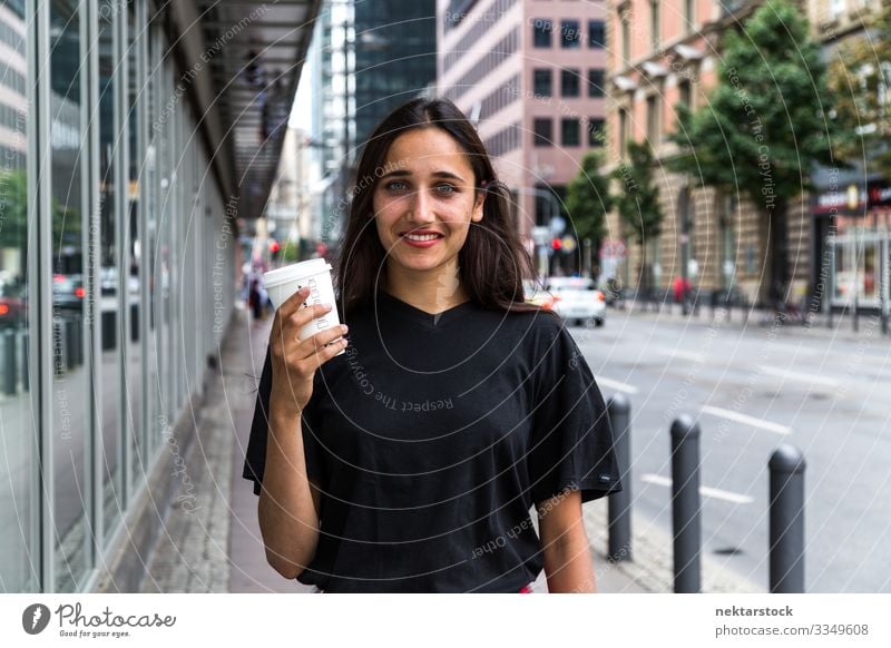 Young woman standing on sidewalk holding paper coffee cup Coffee Lifestyle Beautiful Woman Adults Youth (Young adults) Street Happiness Emotions