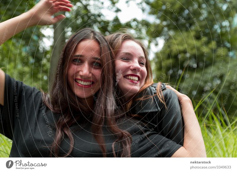 Middle Eastern and Caucasian Girls Hugging and Smiling Joy Beautiful Woman Adults Friendship Youth (Young adults) Nature Grass Embrace Happiness Together Cute