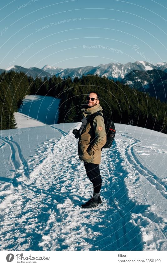 A man in the snow on a mountain on a sunny day with a view of the Alps. Hiking in winter. Human being winter hike Masculine Snow Young man Youth (Young adults)