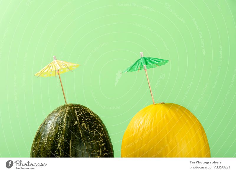 Two melons with cocktail umbrella, Summer melon drink concept Fruit Dessert Organic produce Delicious colorful Conceptual design cucurbitaceae diet food